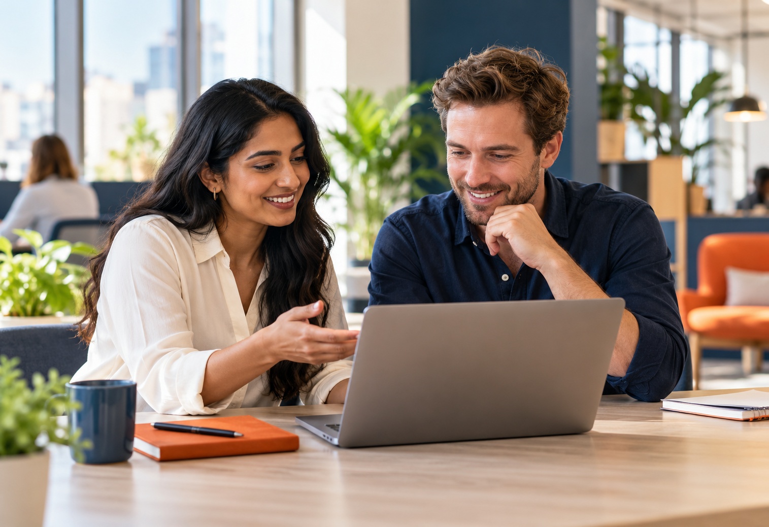 Colleagues collaborating on their next goal at a laptop